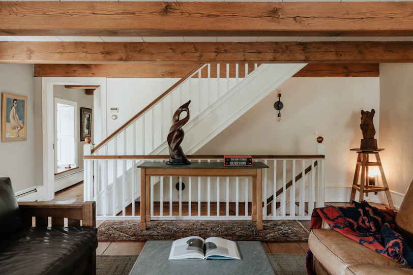 A living room filled with furniture and a staircase