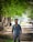 A man standing in the middle of a dirt road