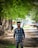 A man standing in the middle of a dirt road