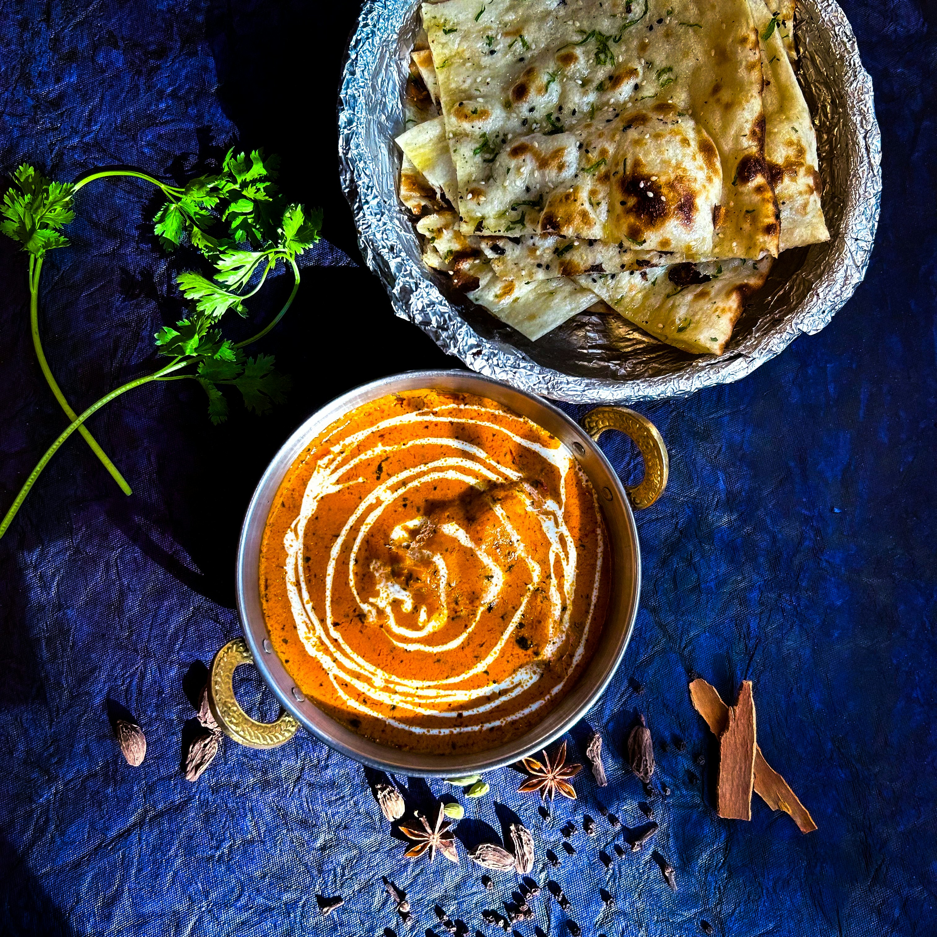 A bowl of food and a bowl of sauce on a table