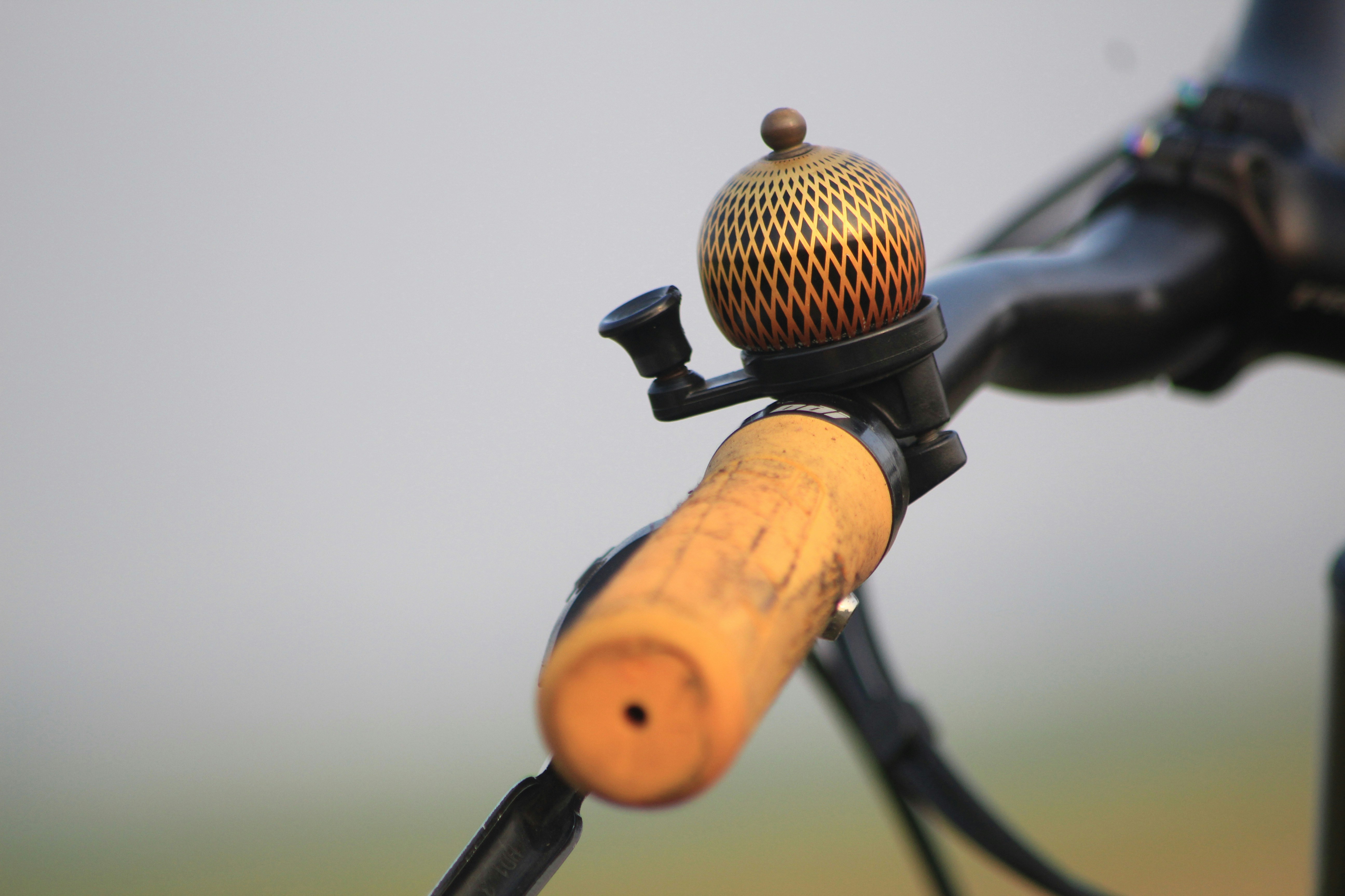A close up of a bike handle with a ball on it