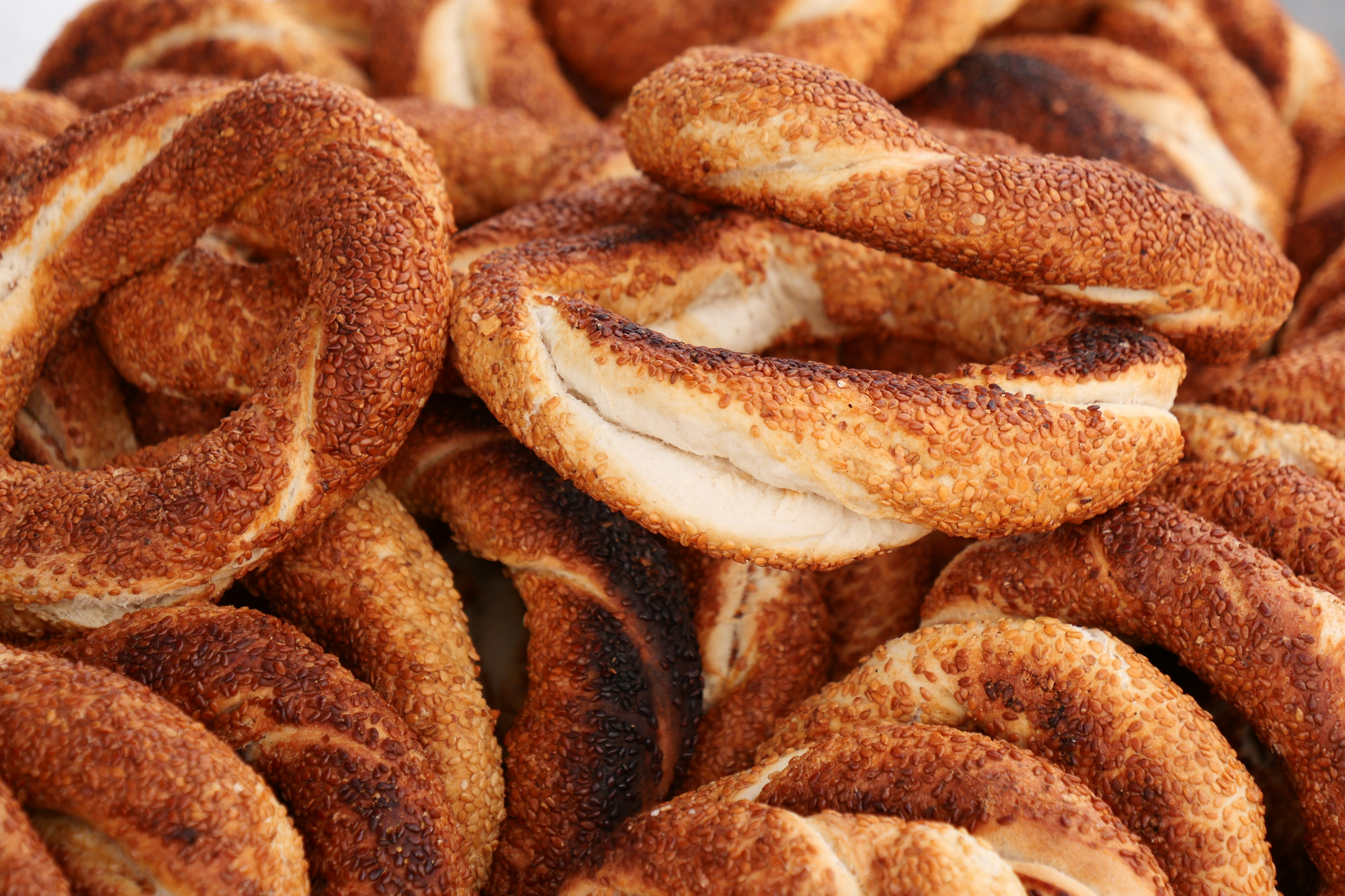 A pile of cinnamon buns sitting on top of a table