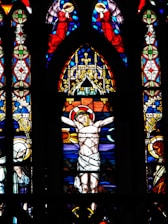 A stained glass window with a crucifix on it