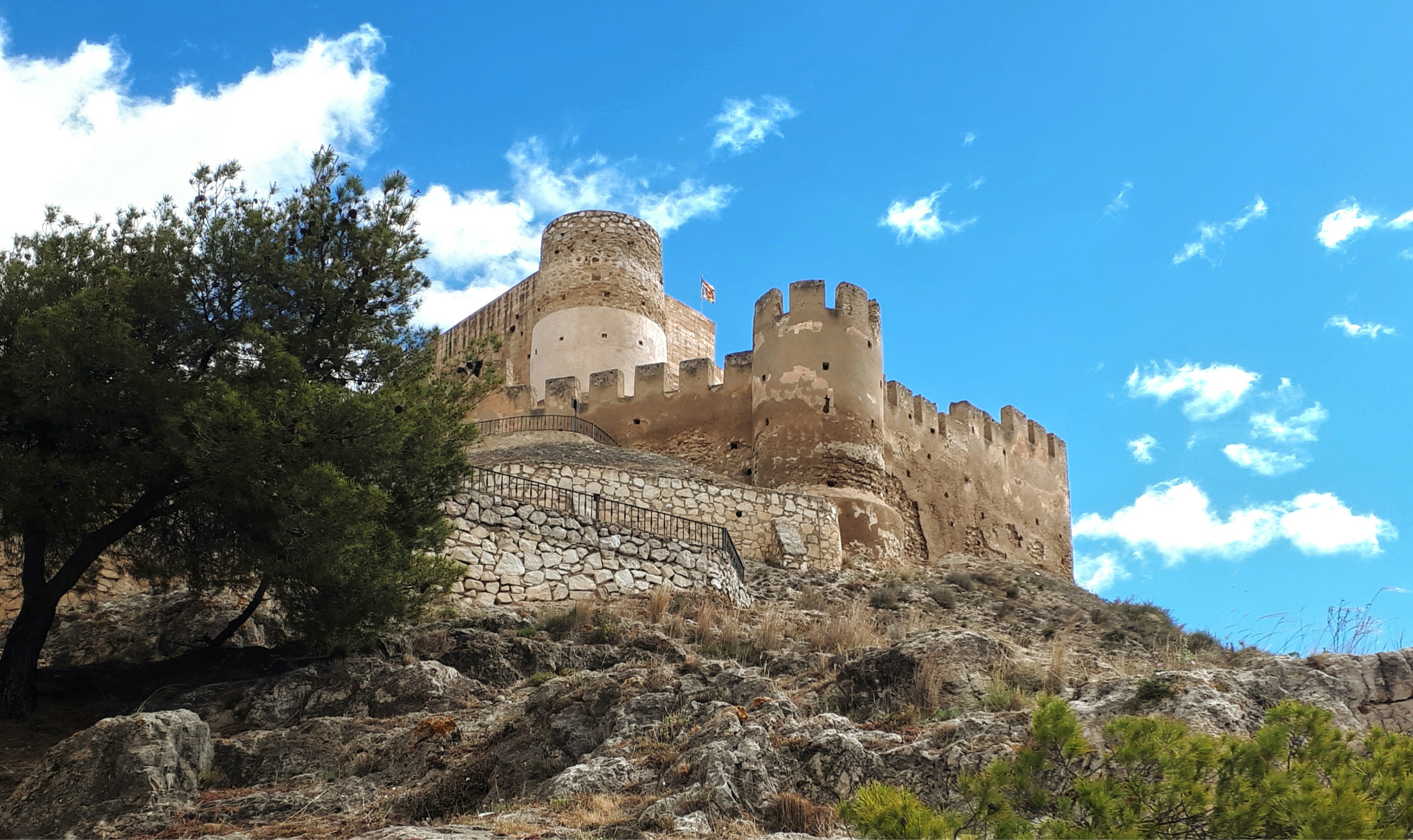 A castle sitting on top of a rocky hill