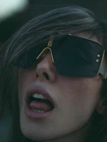 A woman wearing a pair of sunglasses with her mouth open