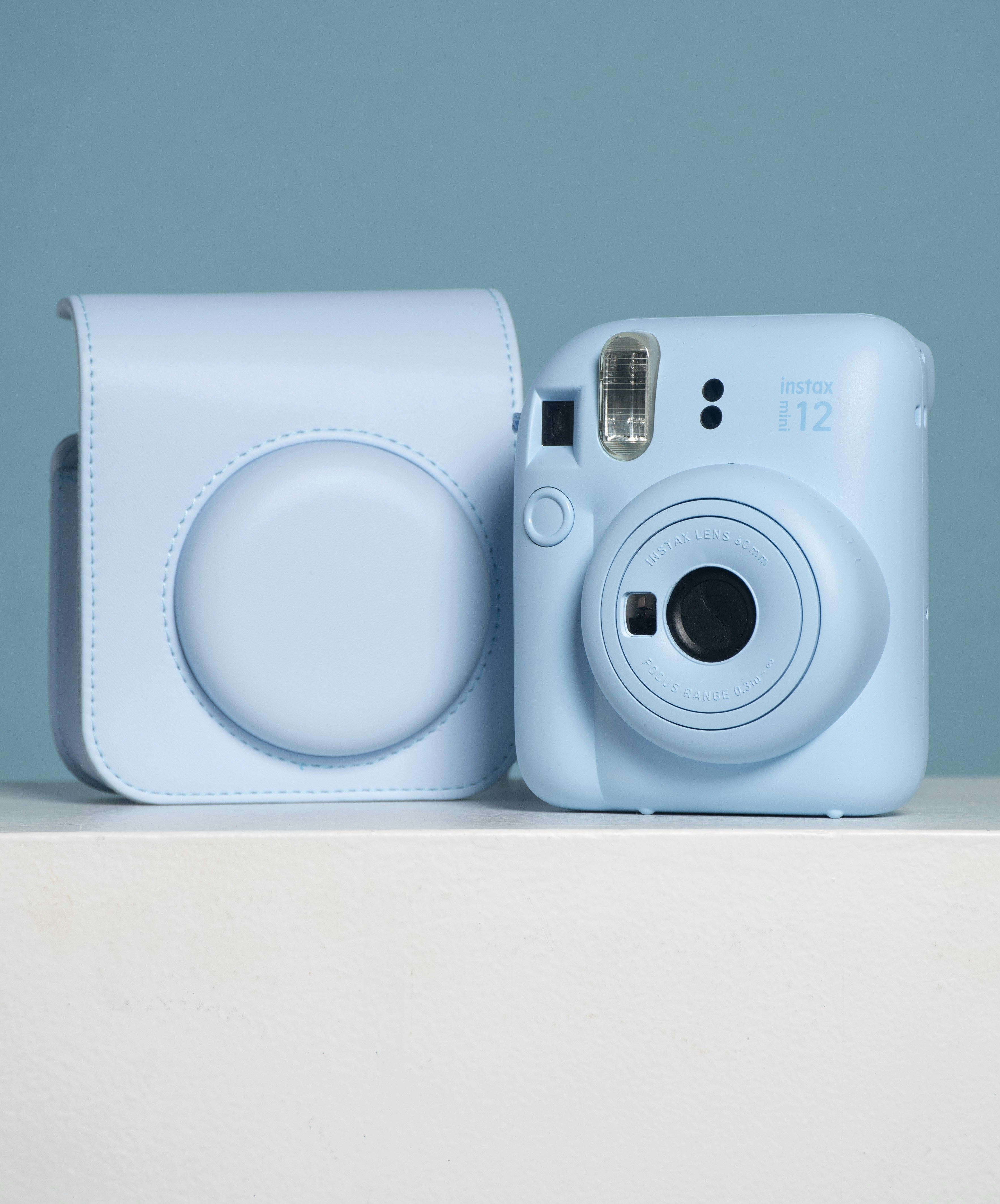 A blue camera sitting on top of a table photo – Free Camera Image on ...