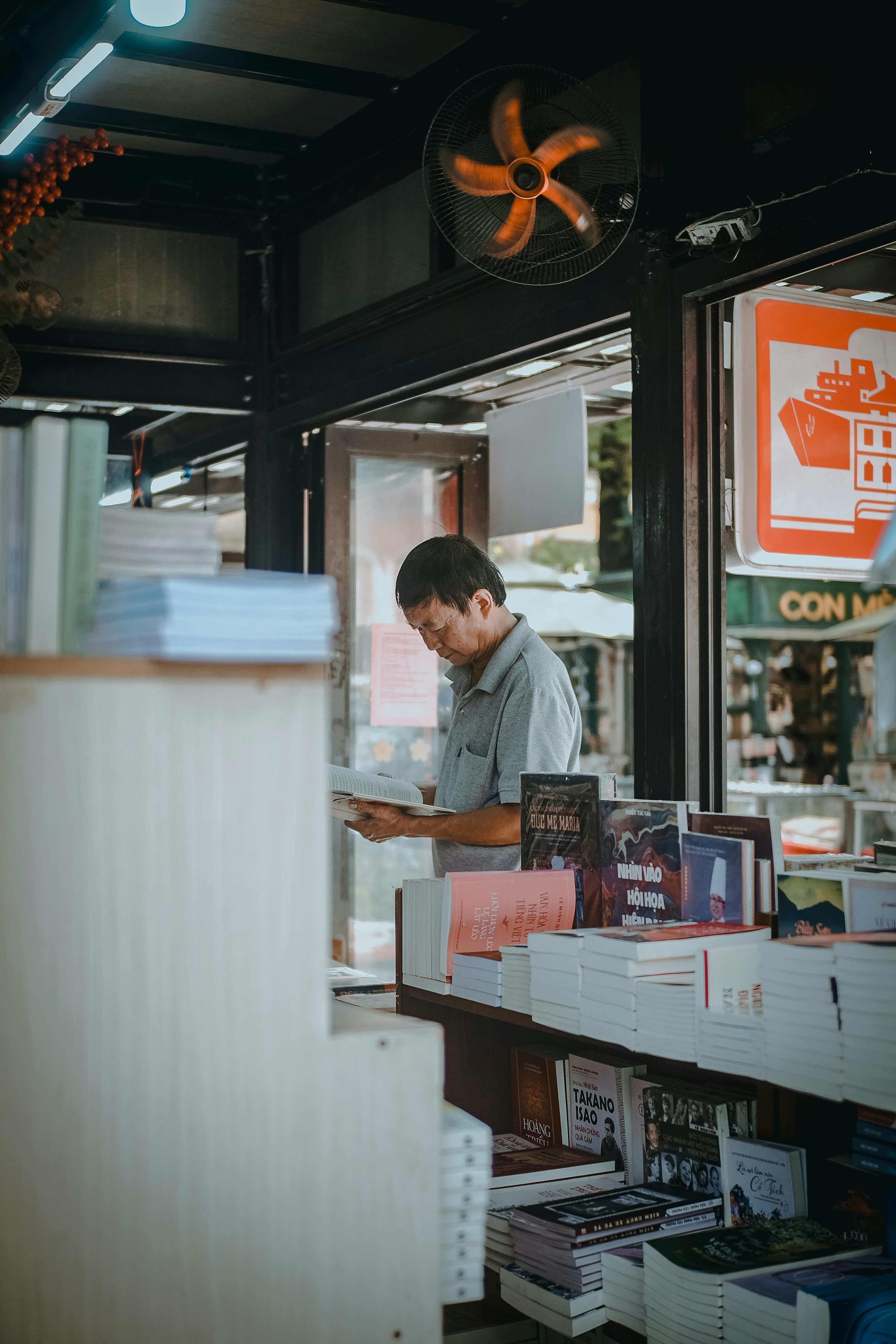 A man standing in front of a book store
