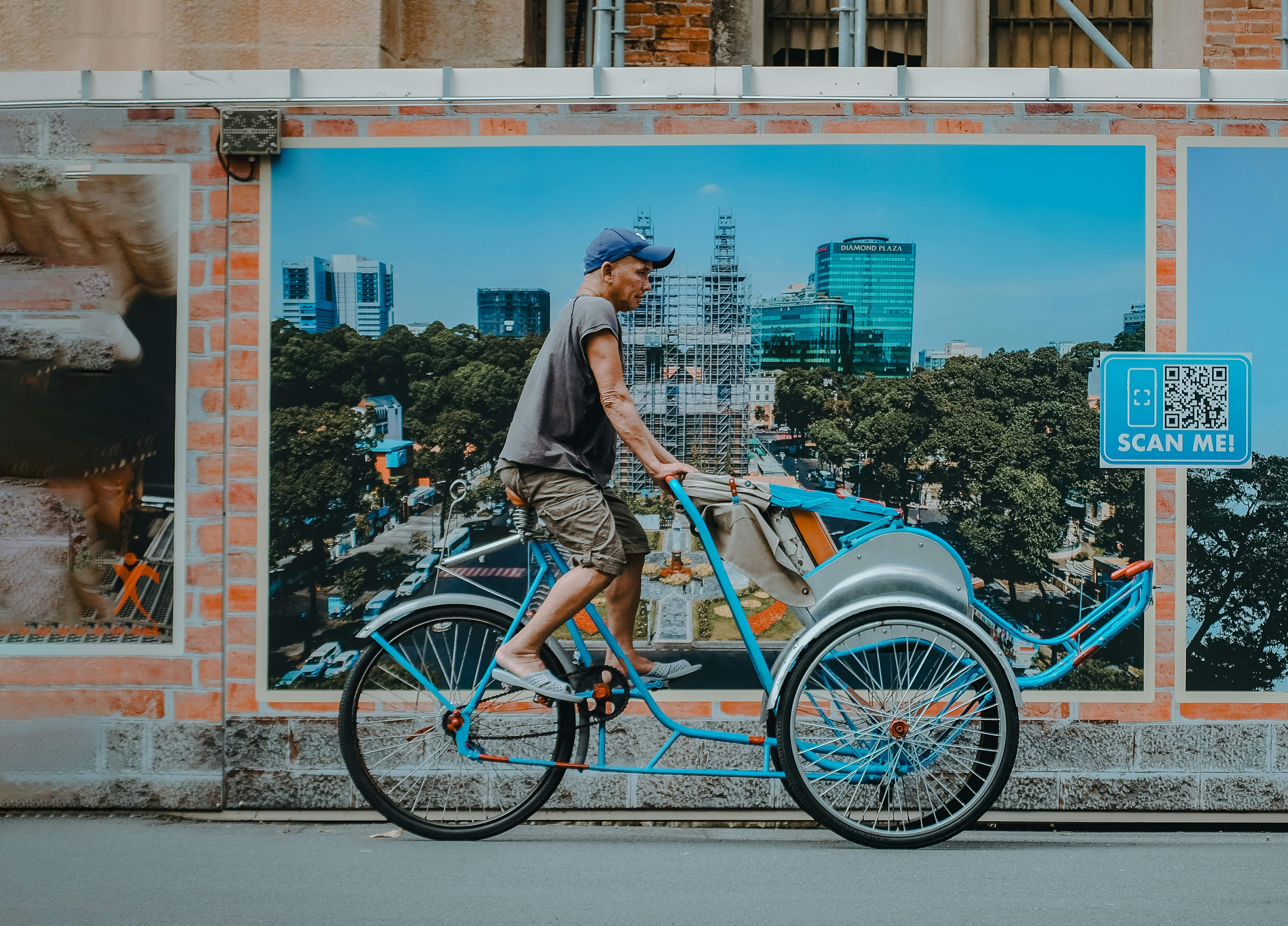 A man riding a bike down a street next to a building