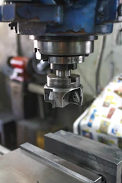 A machine that is working on a piece of metal