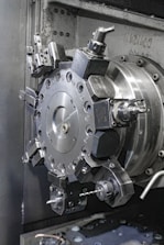 A close up of a machine that is working on a piece of metal