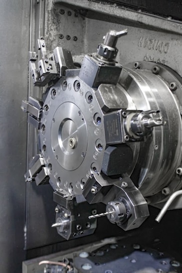 A close up of a machine that is working on a piece of metal