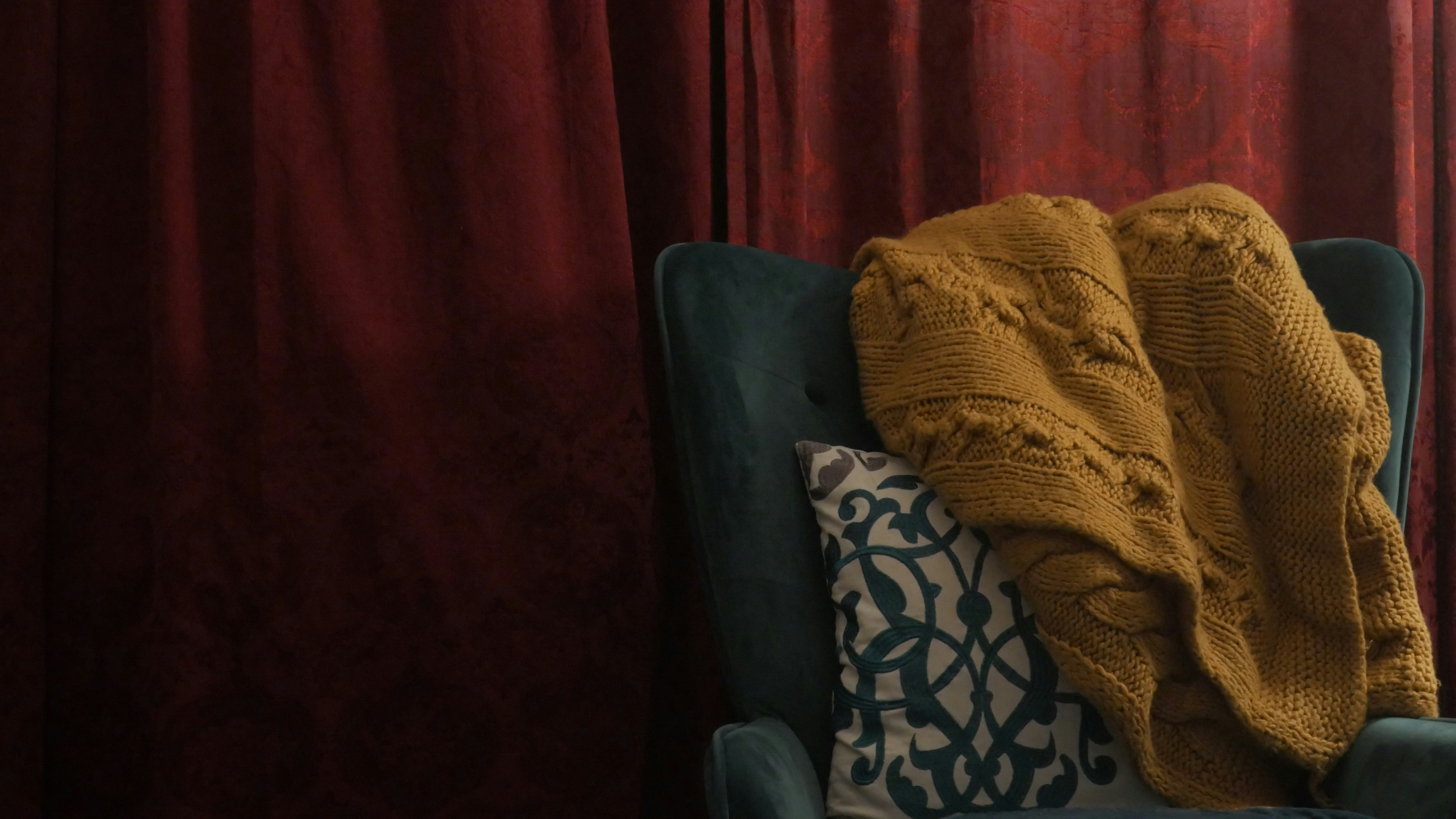 A chair with a blanket on top of it