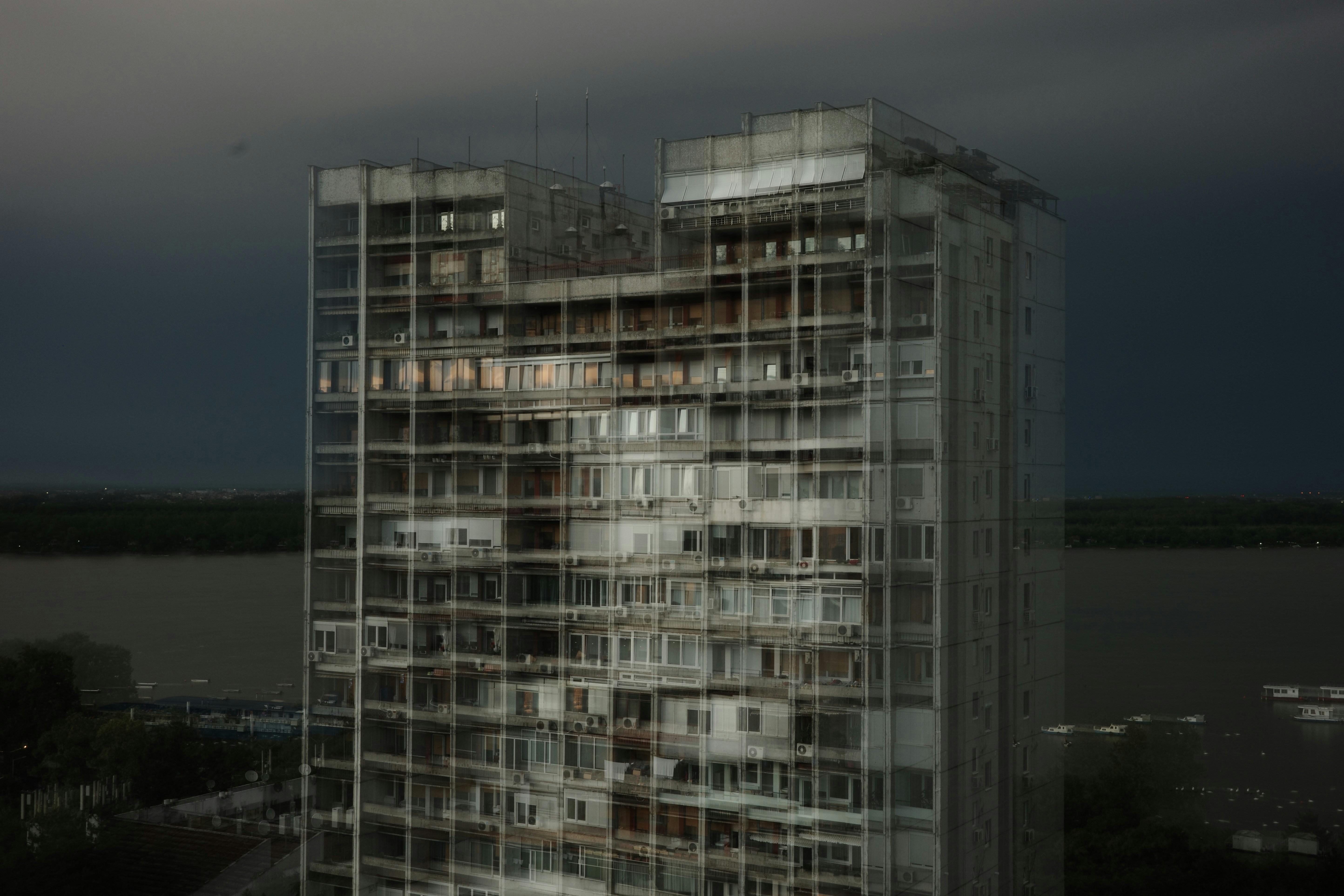 A very tall building sitting next to a body of water (Photo by Dmitrii Filatov on Unsplash)