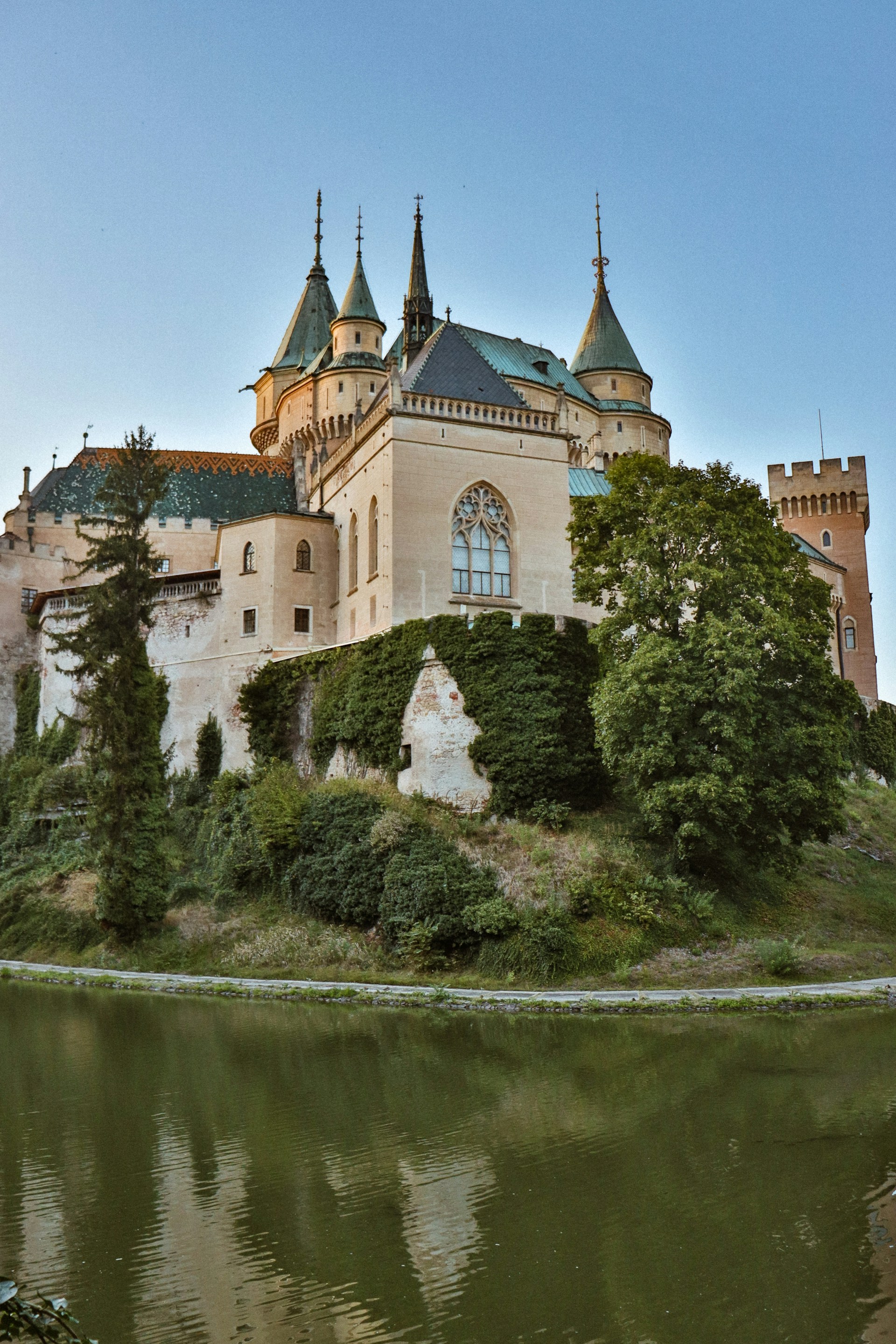 A castle with a lake in front of it