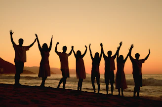 A group of people standing on top of a beach