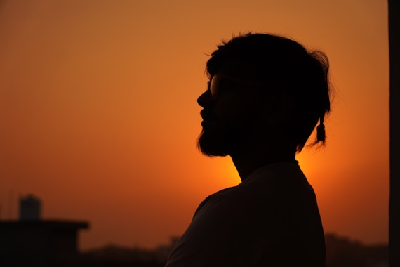 A silhouette of a man in front of a sunset