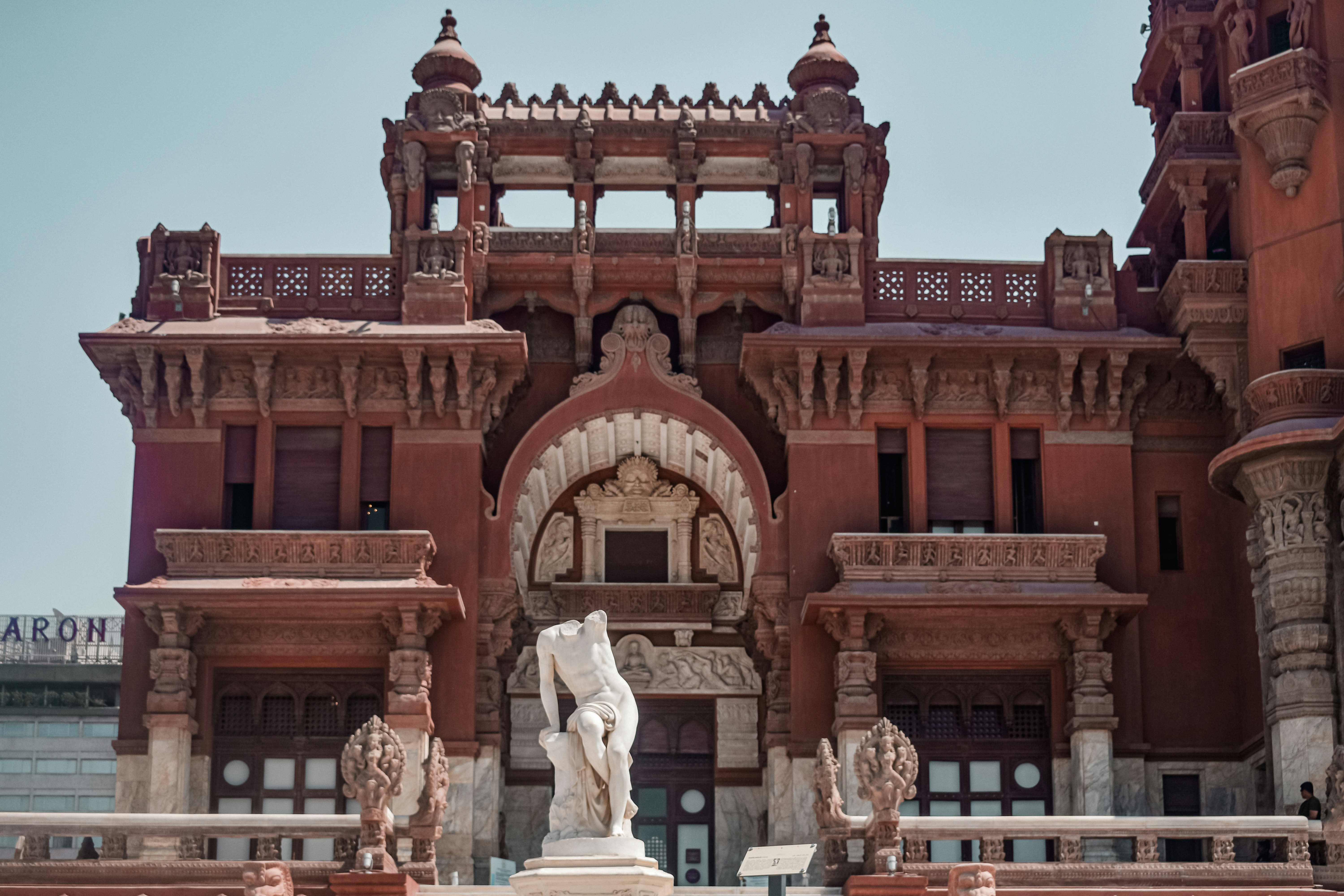 A large building with a statue in front of it