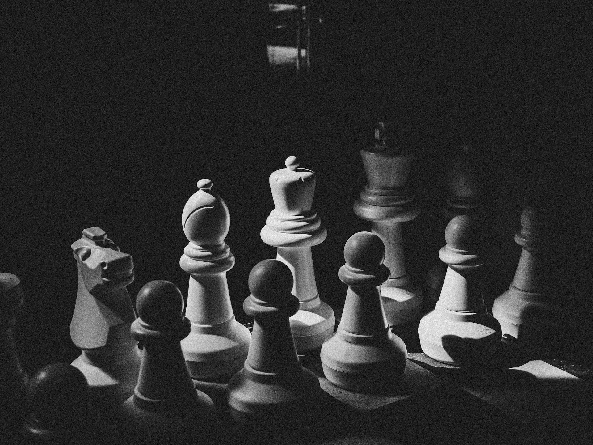 A black and white photo of chess pieces