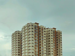 A very tall building sitting next to a body of water