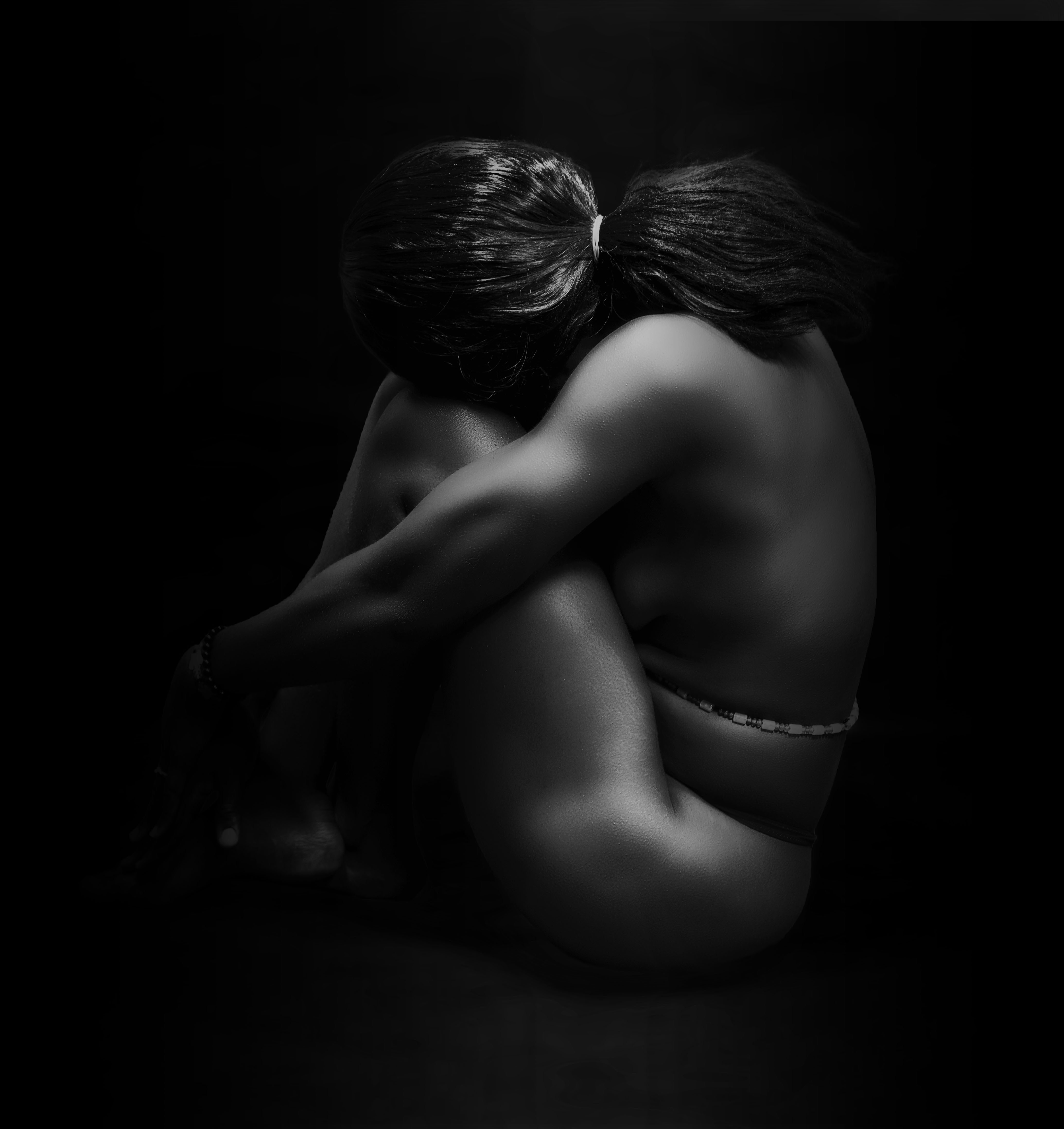 A couple of naked women sitting next to each other