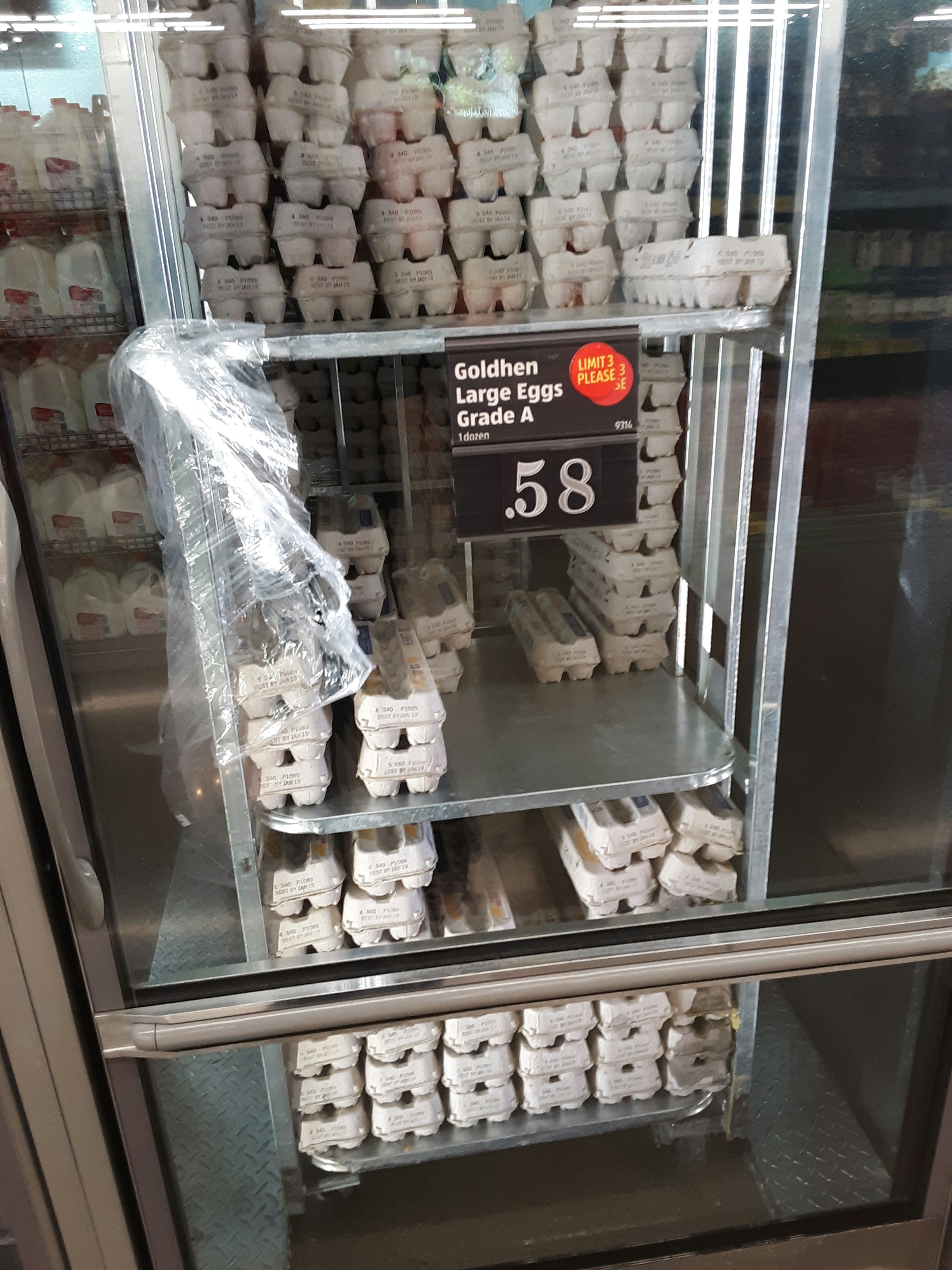 A display case filled with lots of white donuts