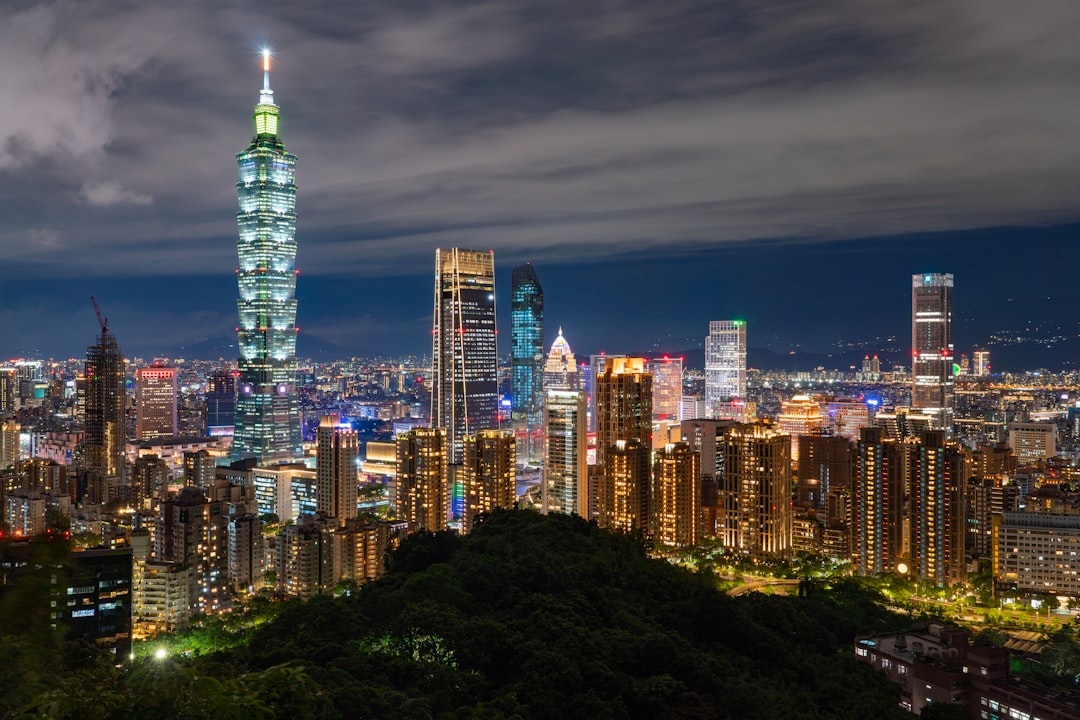A view of a city at night from the top of a hill,
