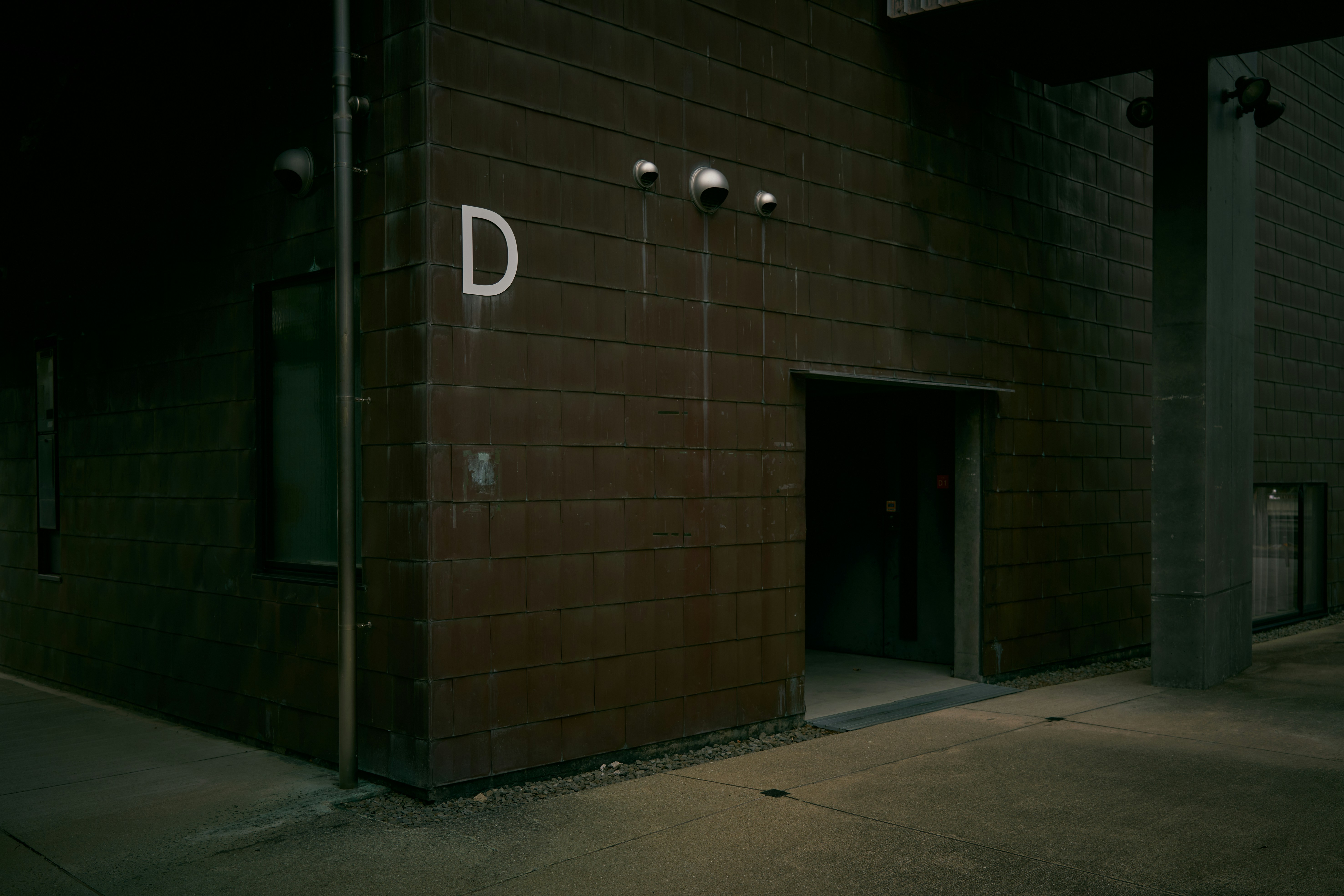 A building with a door and a sign on the side of it