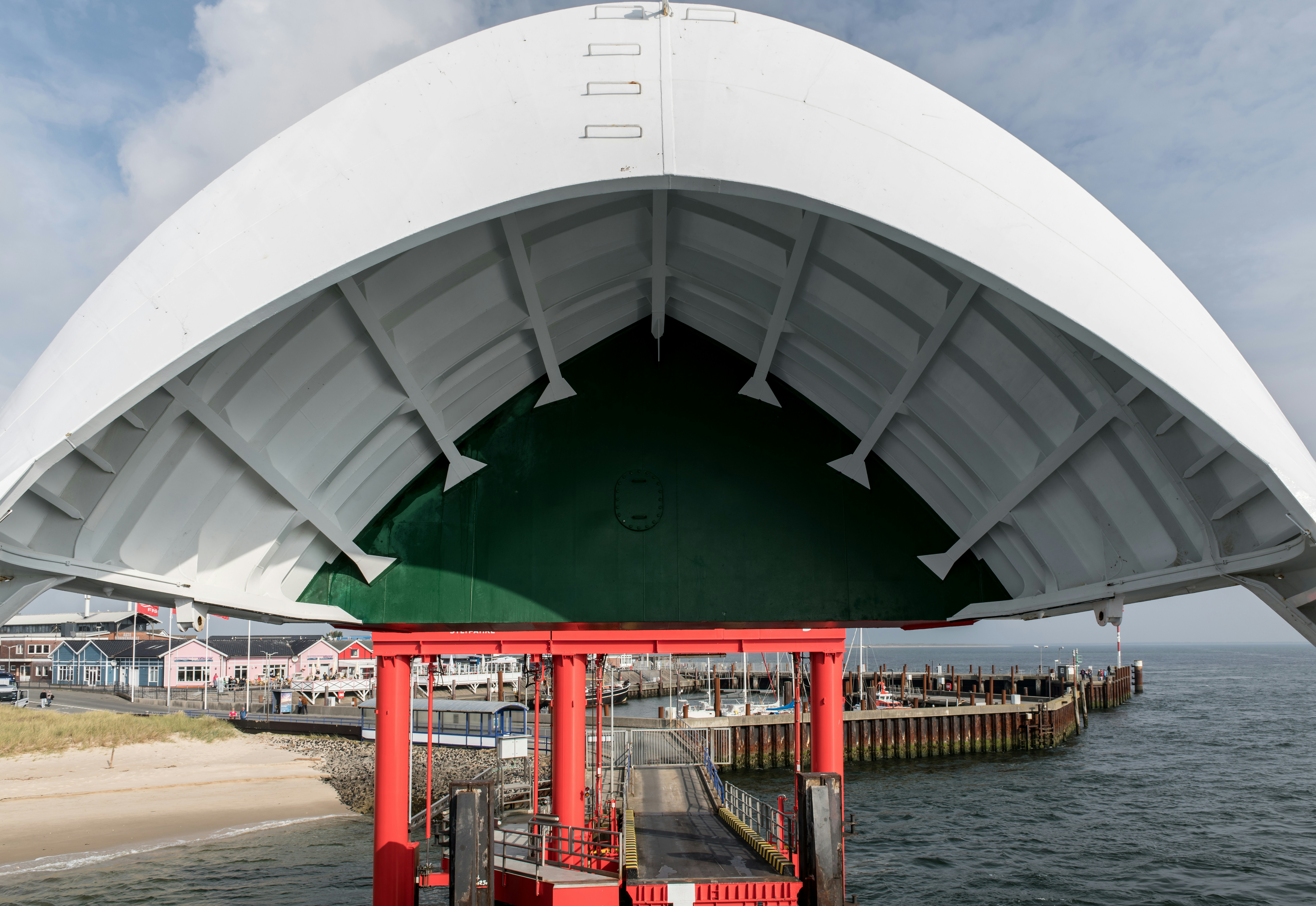 A large white structure sitting on top of a body of water