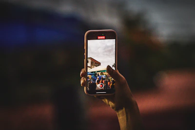 A person taking a picture with a cell phone