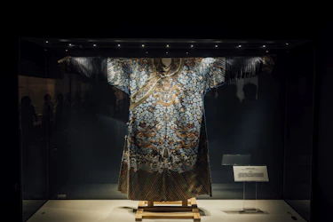 A mannequin is displayed in a dark room
