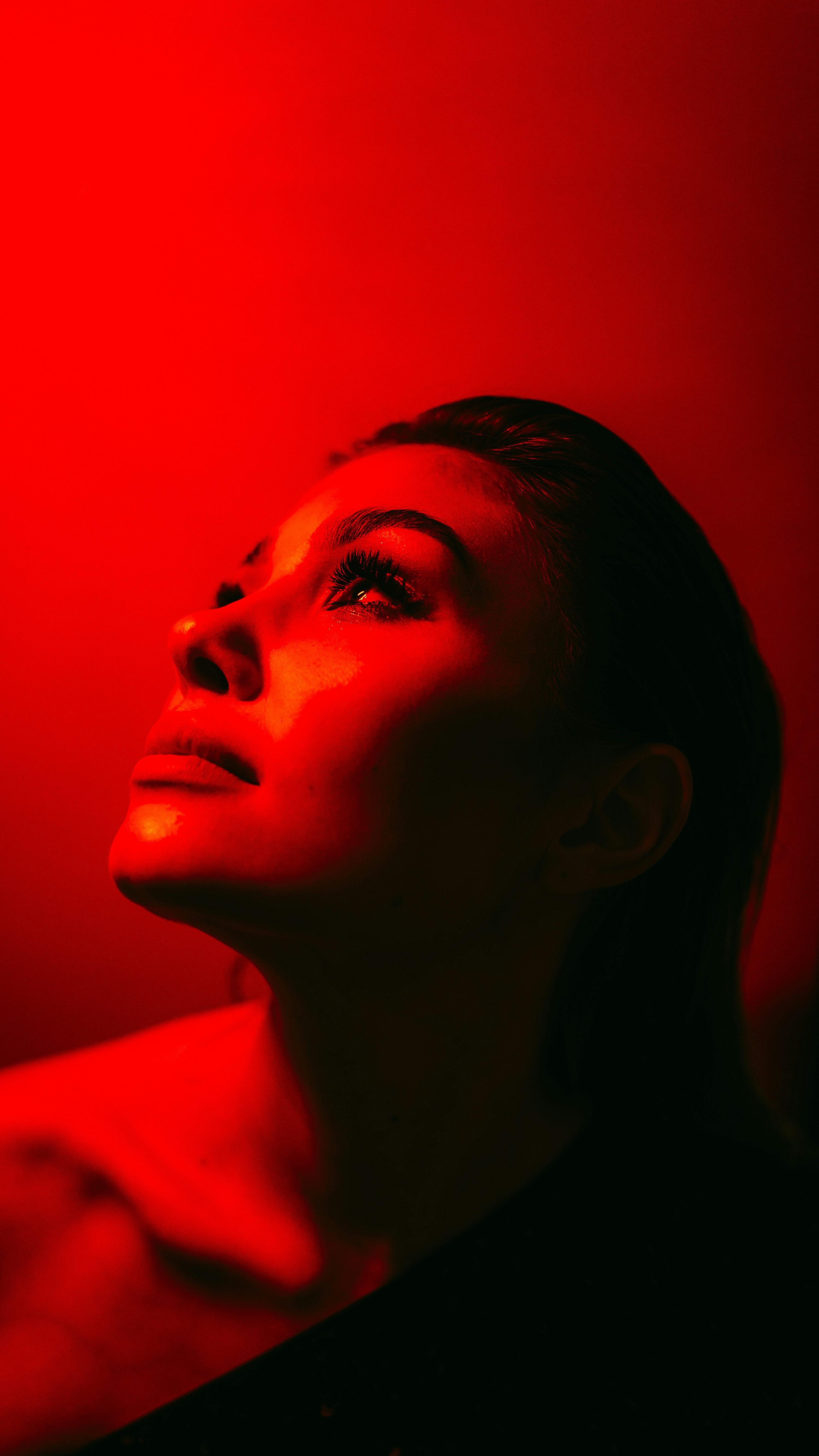 A woman in a black shirt is holding a cell phone