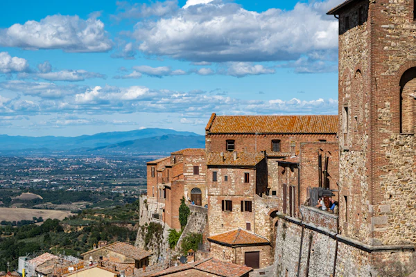 Stone buildings and ramparts in Montepulciano above the countryside
