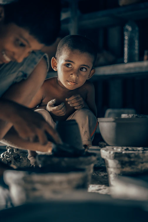 A woman and a child are cooking in a kitchen