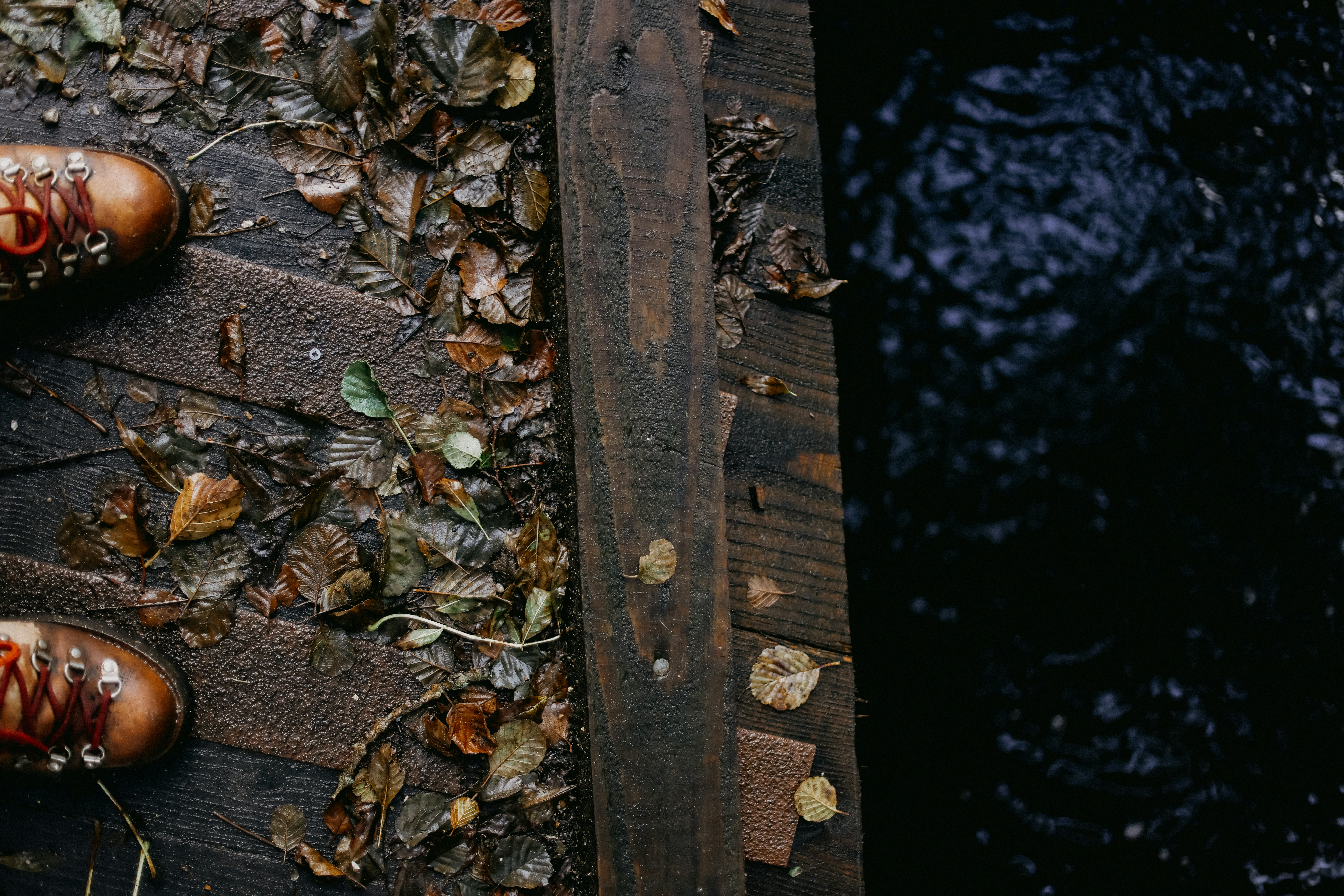 A pair of brown shoes sitting on top of a wooden floor