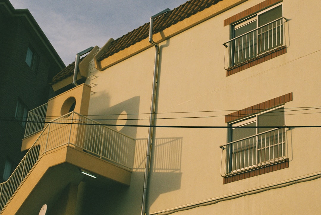 A yellow building with a balcony and balconies,