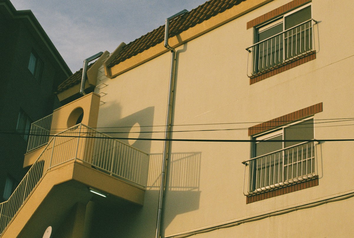 Yellow exterior apartment with balcony