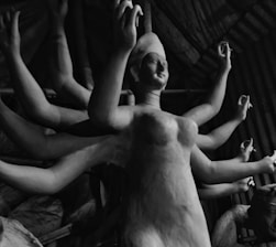 A black and white photo of a group of naked women