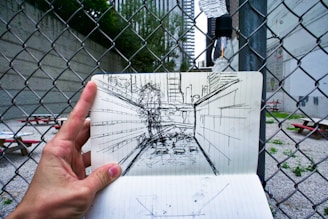 A person holding a piece of paper with a drawing on it