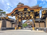 A large asian gate with a sky background