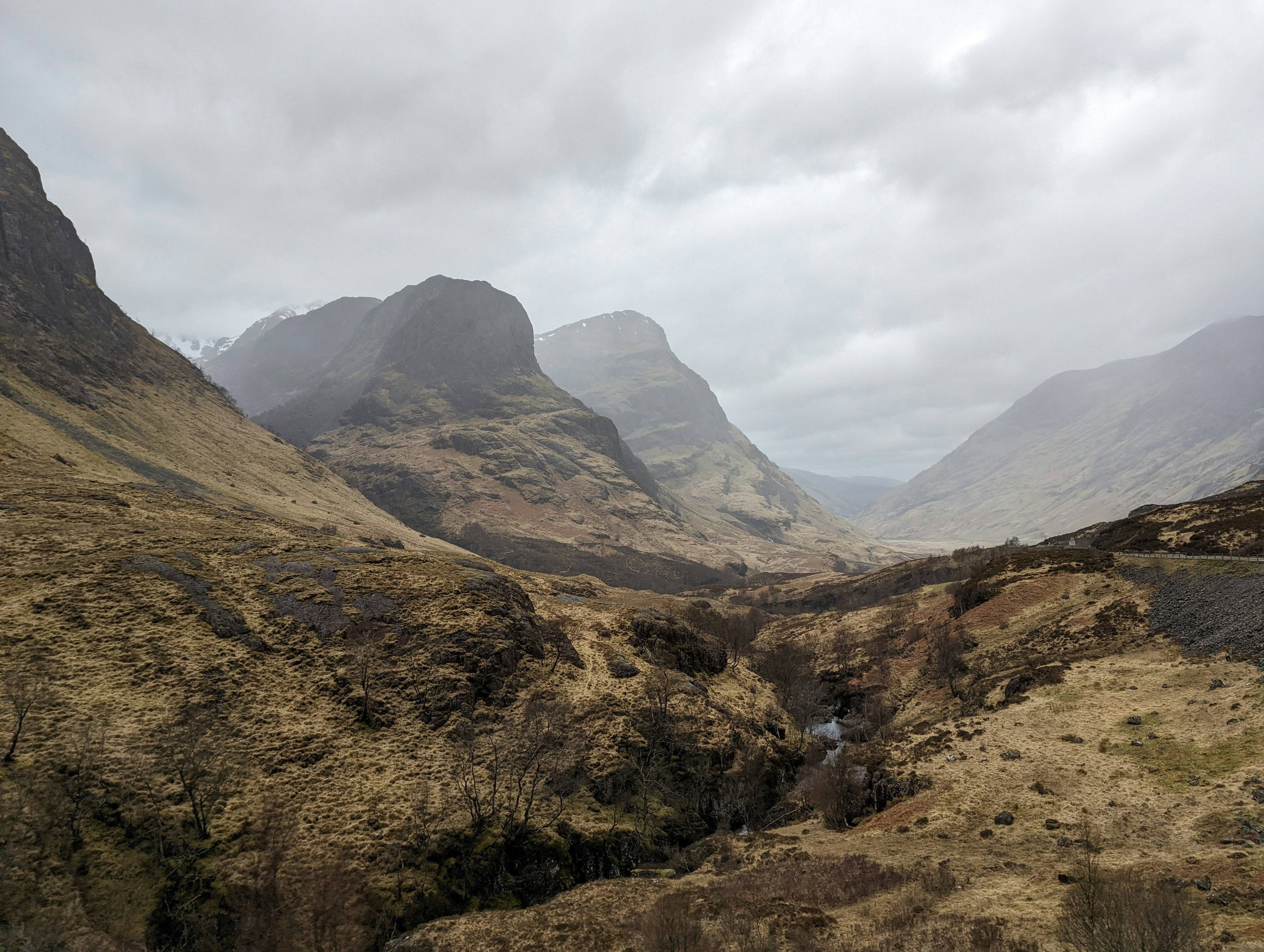 A view of a valley with mountains in the background
