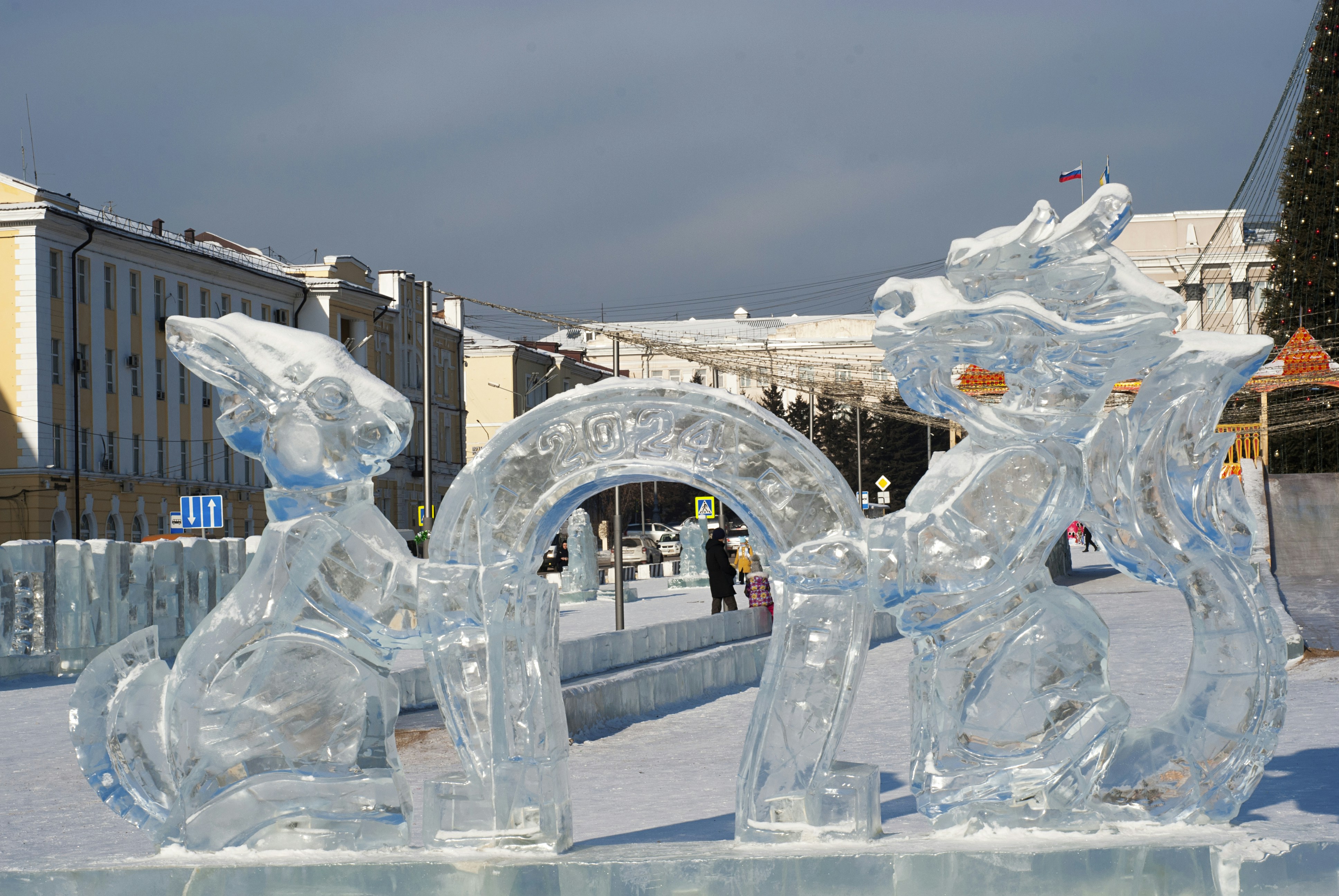 A couple of ice sculptures sitting on top of a snow covered gro…