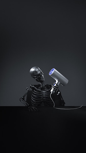 A skeleton with a hair dryer on its head