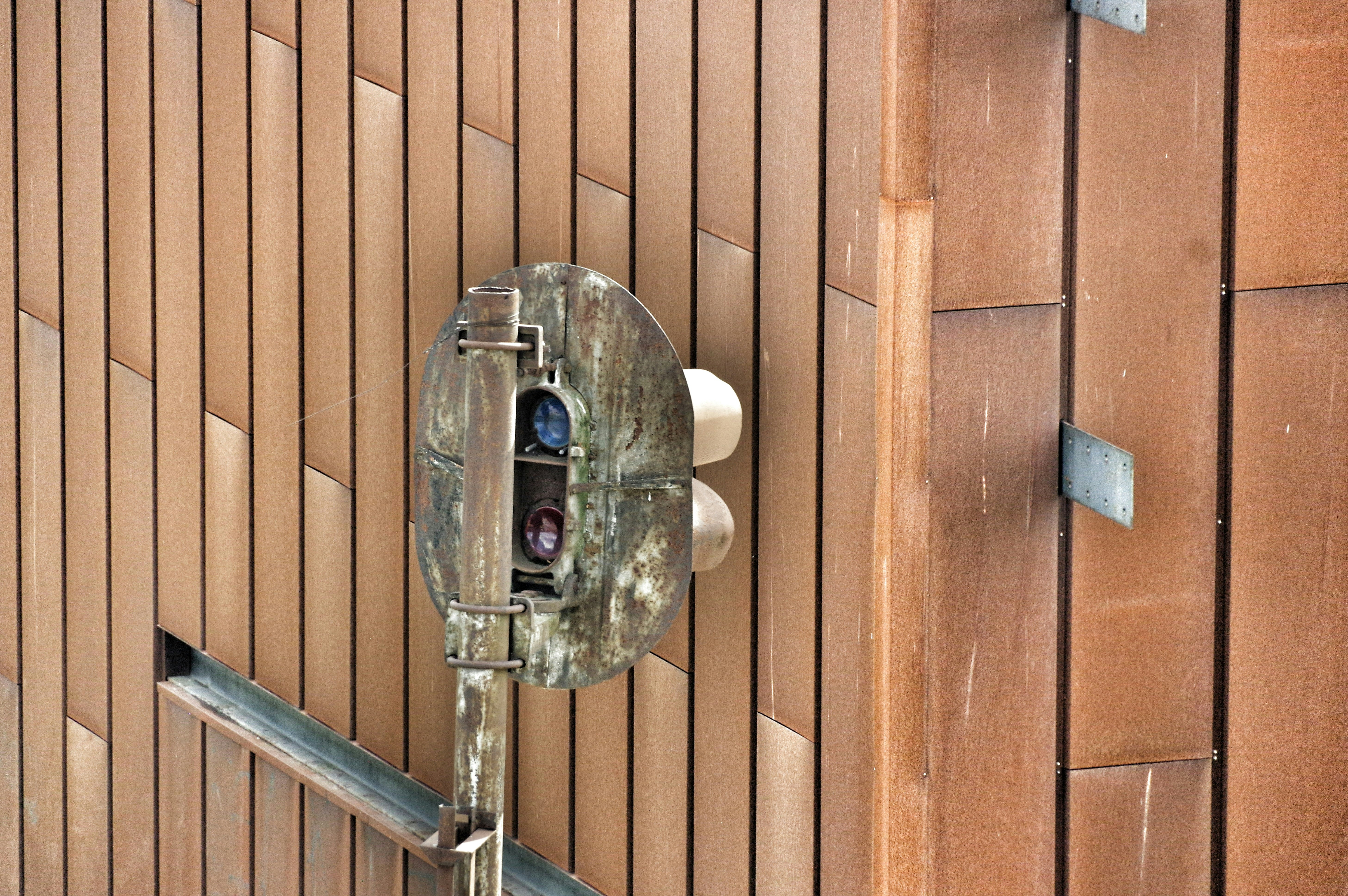 A cell phone is attached to a wooden wall