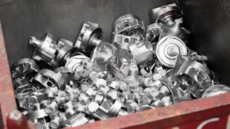 A red box filled with lots of silver objects