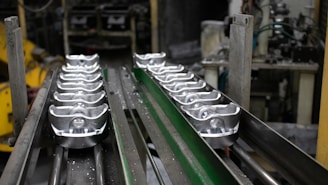 A conveyor belt with a bunch of metal objects on it