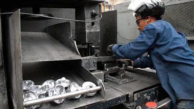 A man working on a machine in a factory