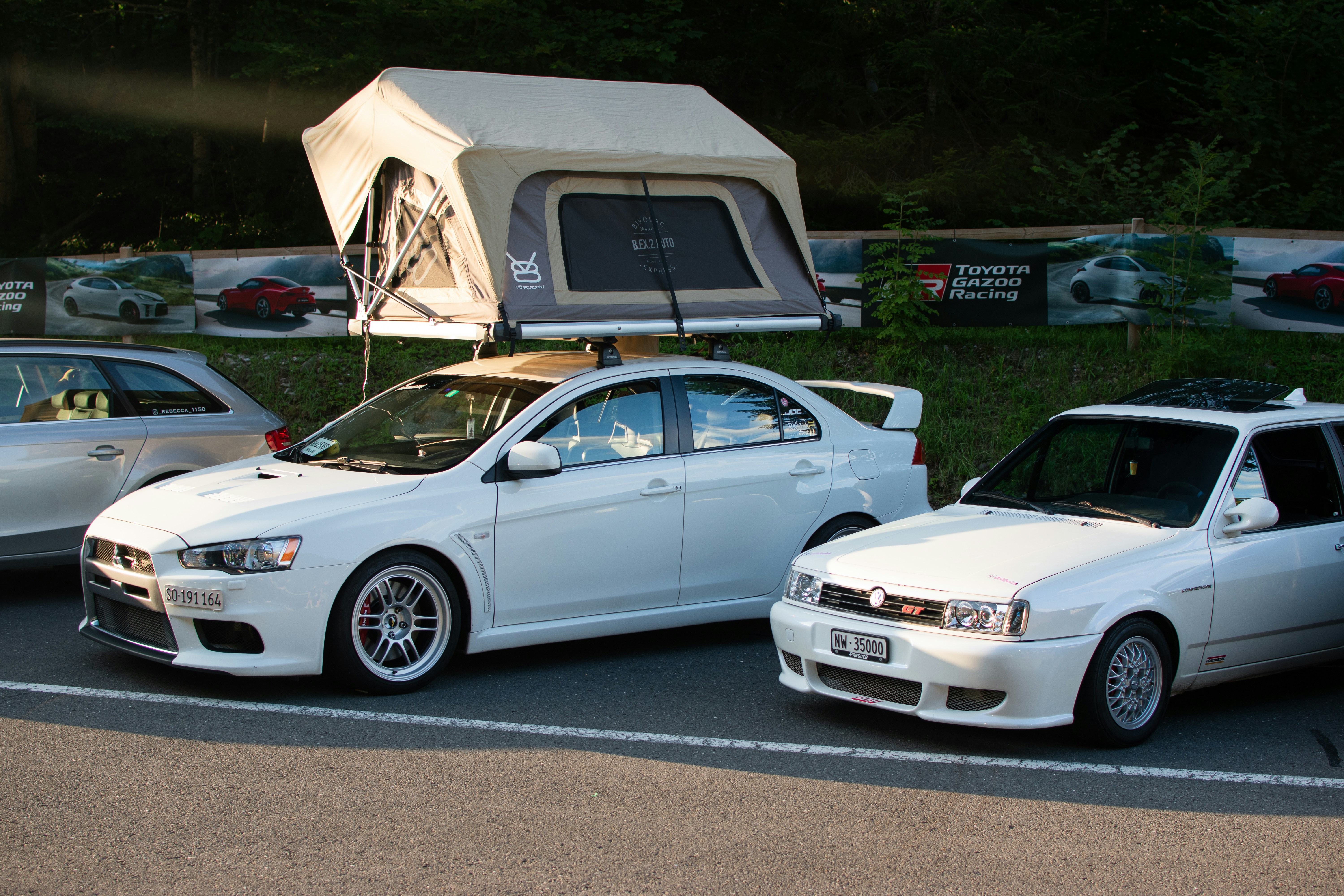 A couple of cars parked next to each other in a parking lot photo ...