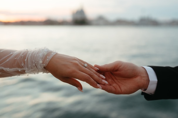A close up of a person holding another person's hand