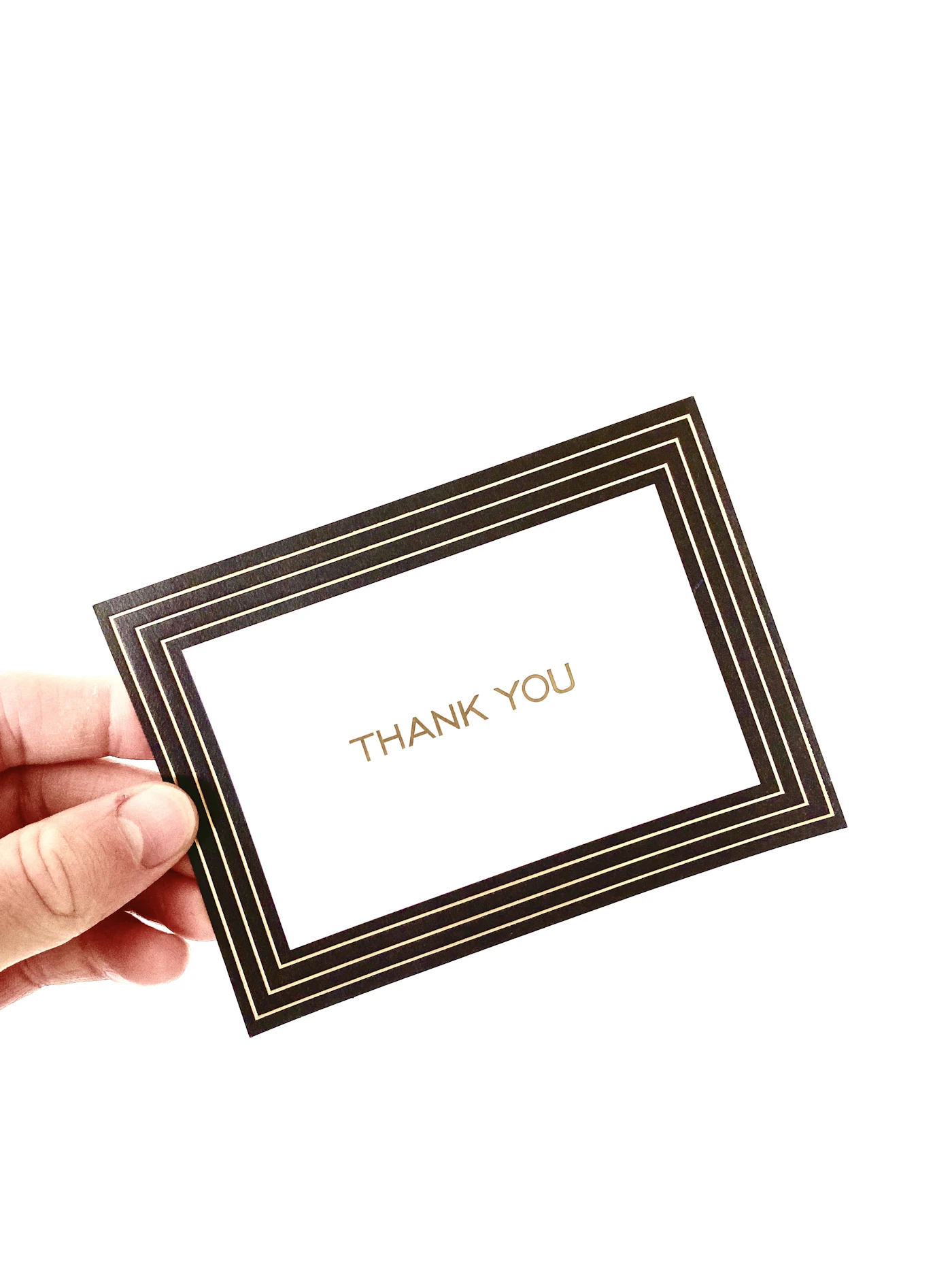 How to craft wedding thank you cards — A stack of personalized wedding thank you cards with envelopes ready to be mailed.