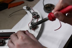 A person is working on some electrical equipment
